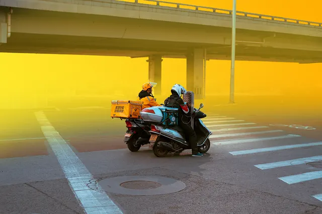 Delivery scooter under overpass with yellow cast, photographic, vibrant