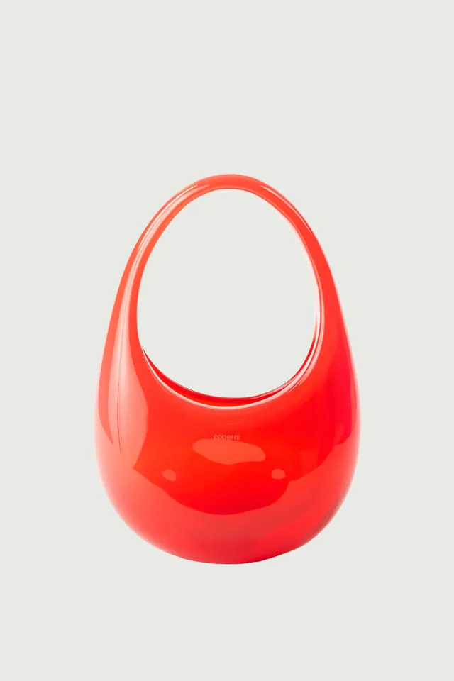 Red glossy oval vessel or vase with opening, photographic, minimal, vibrant