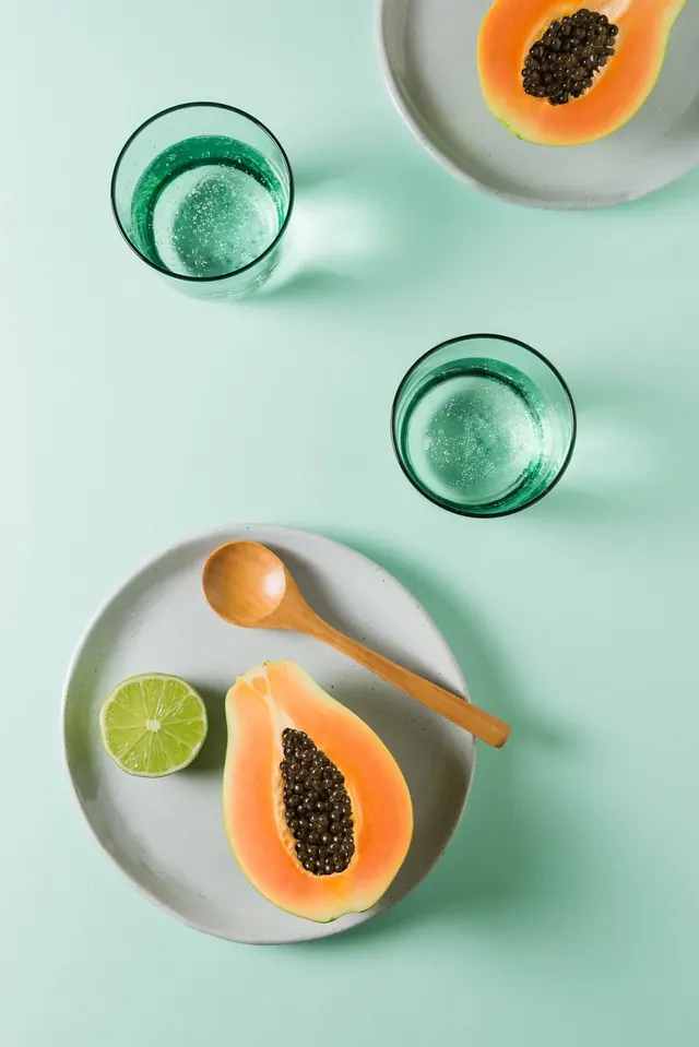 Cocktail and fruit flat lay on mint background, photographic, minimal, cool