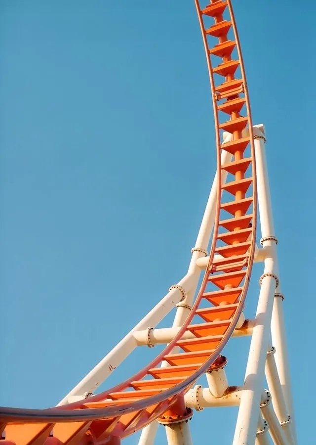 Roller coaster loop against clear blue sky, photographic, technical, vibrant