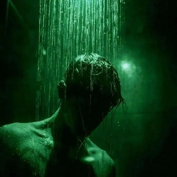 Figure in heavy rain with green light, photographic, technical, dark