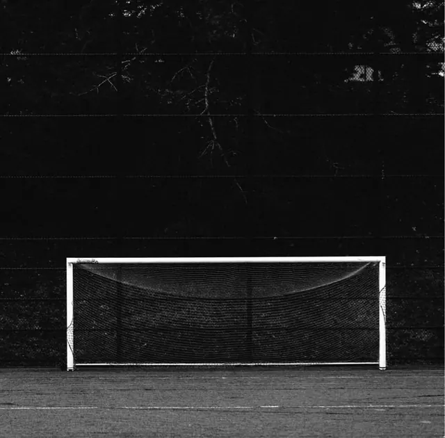 Soccer goal with net against dark background, photographic, monochrome, monochrome