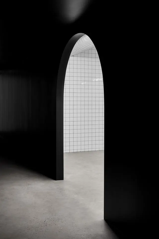 Minimalist archway interior with grid detail, photographic, minimalist, monochrome