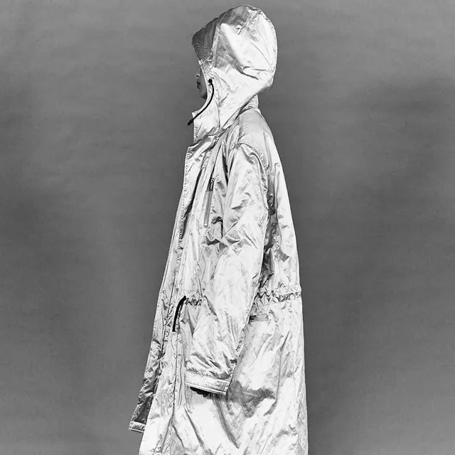 Fashion portrait with translucent head cover, photographic, editorial, monochrome