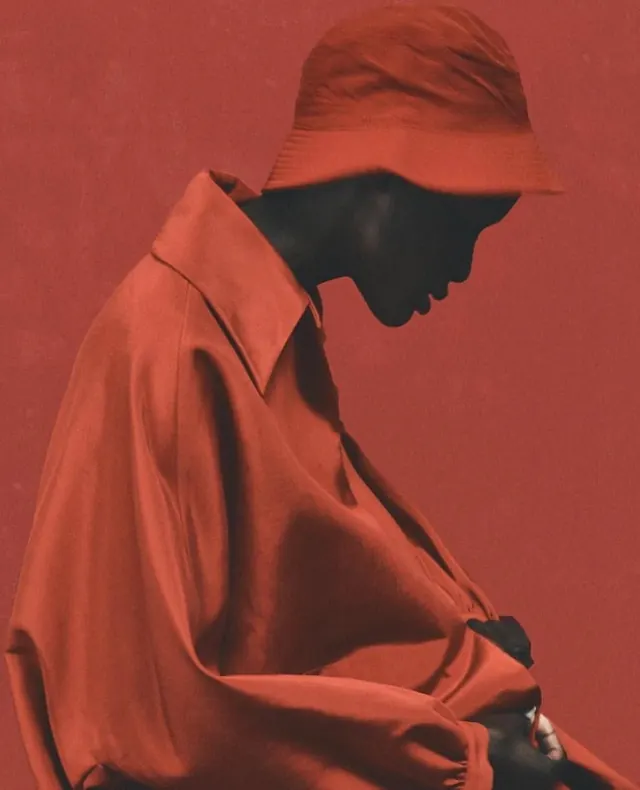 Fashion portrait in coral-red silhouette, photographic, editorial, warm