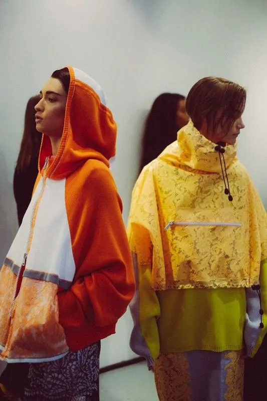 Two figures in vibrant layered outfits, photographic, editorial, vibrant