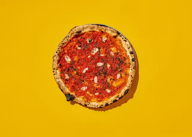 Rosso pizza on bold yellow background, photographic, flat, vibrant