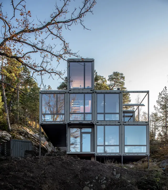 Modular container architecture against natural landscape, photographic, technical, cool