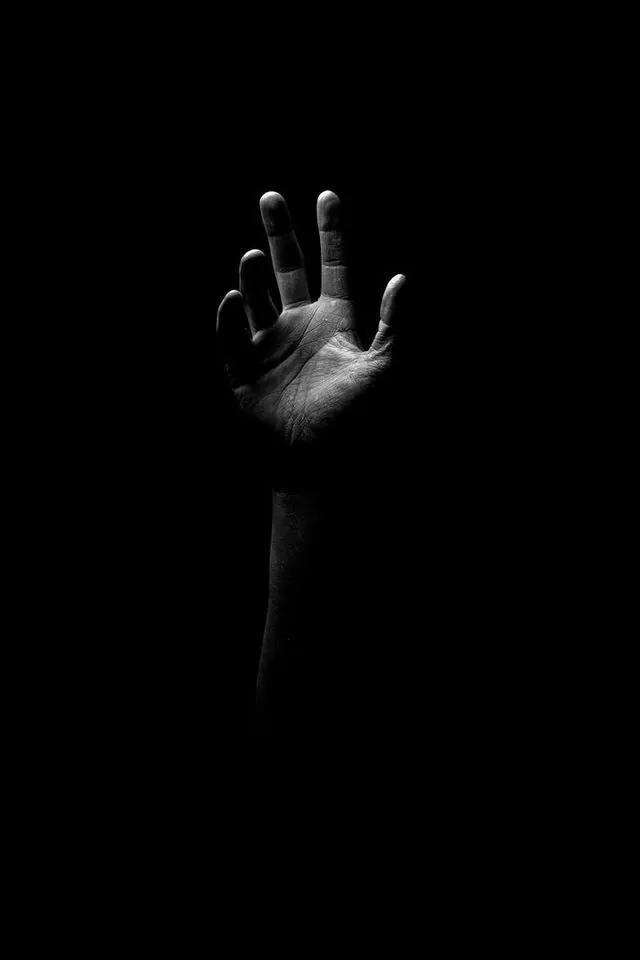 Open hand on black background studio portrait, photographic, technical, monochrome