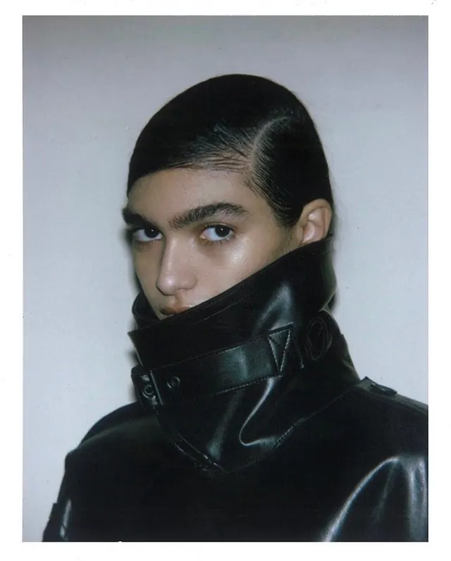 Close-up portrait with black leather collar, photographic, minimalist, monochrome
