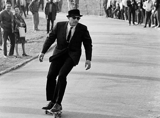 Man in Suit Walking on Street