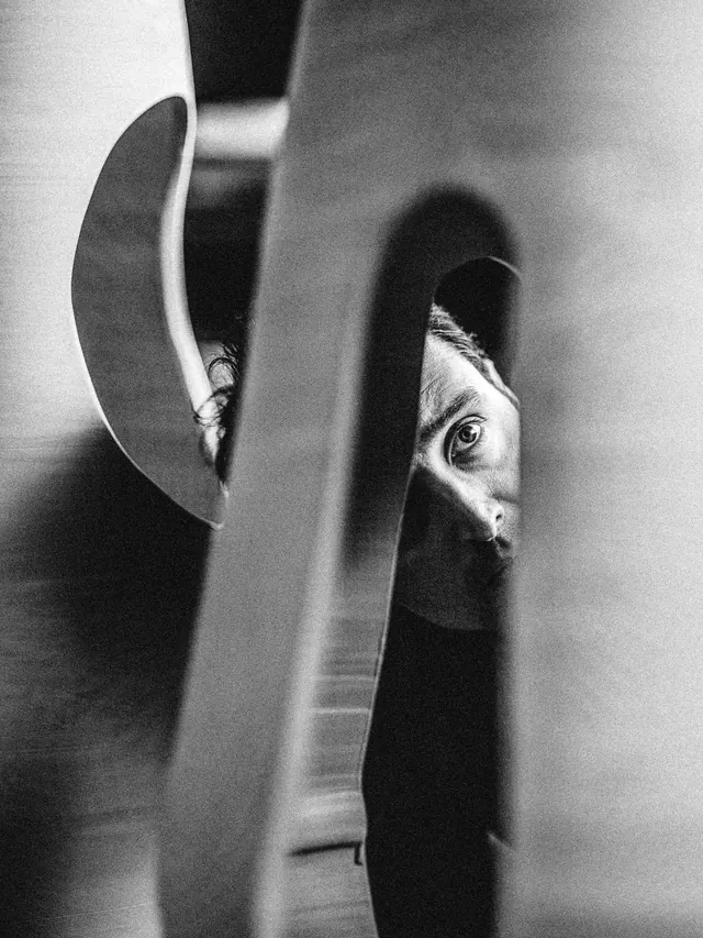 Black and white portrait through architectural frame, photographic, monochrome, dark