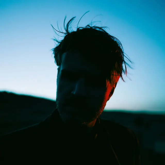 Portrait with color gel lighting, photographic, bold, dark