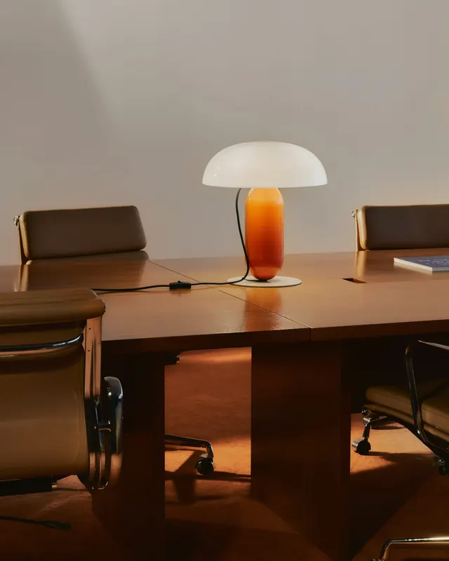 Modern desk lamp on wood work surface, minimal, organic, warm