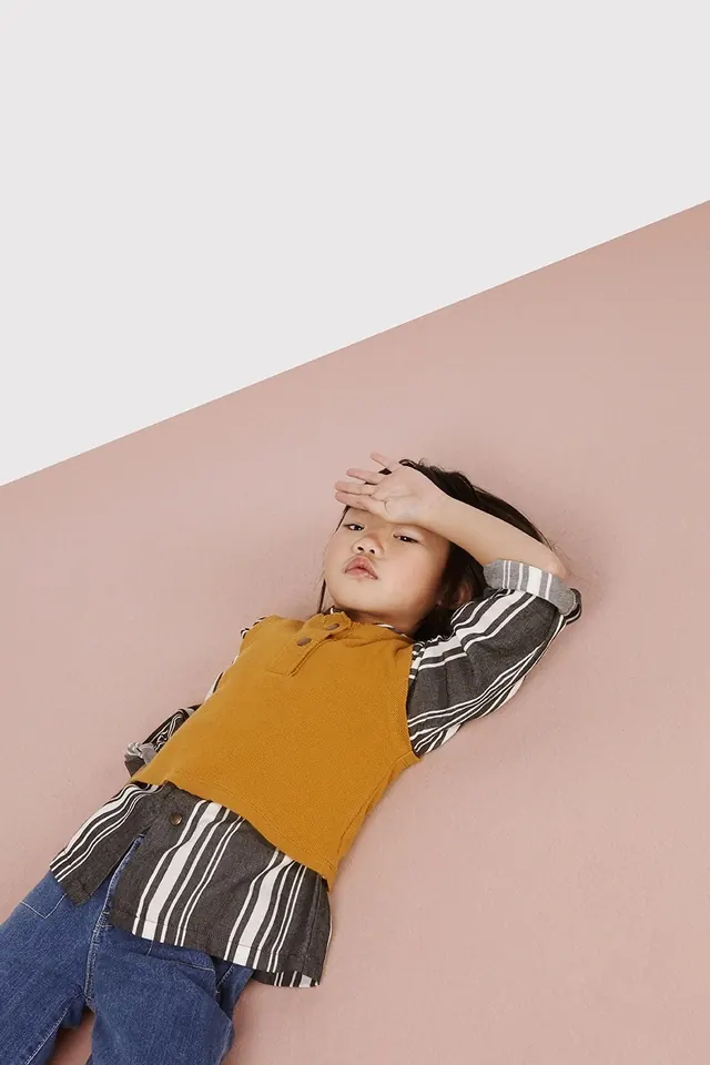Kids fashion flat lay with contrasting colors, playful, photographic, warm