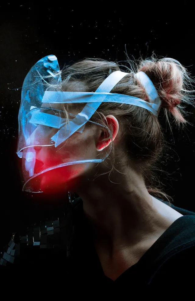 Neon-wrapped face with blue and red light, photographic, dark-mode, dark