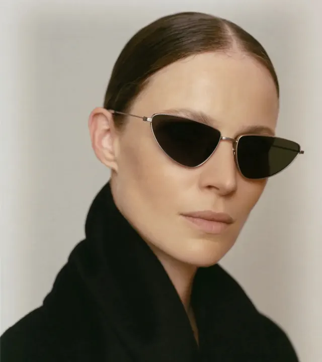 Sunglasses portrait on neutral background, photographic, minimal, light