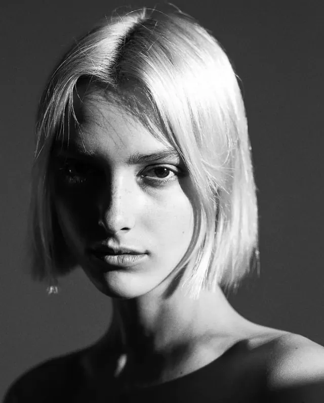 Classic black-and-white portrait with side lighting, photographic, minimal, monochrome