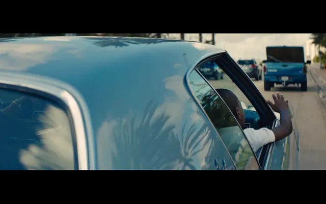 Hand waving from car window with highway traffic, photographic, cinematic, cool
