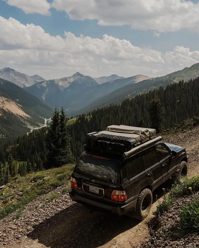 SUV on mountain overlook with valley view, photographic, technical, dark