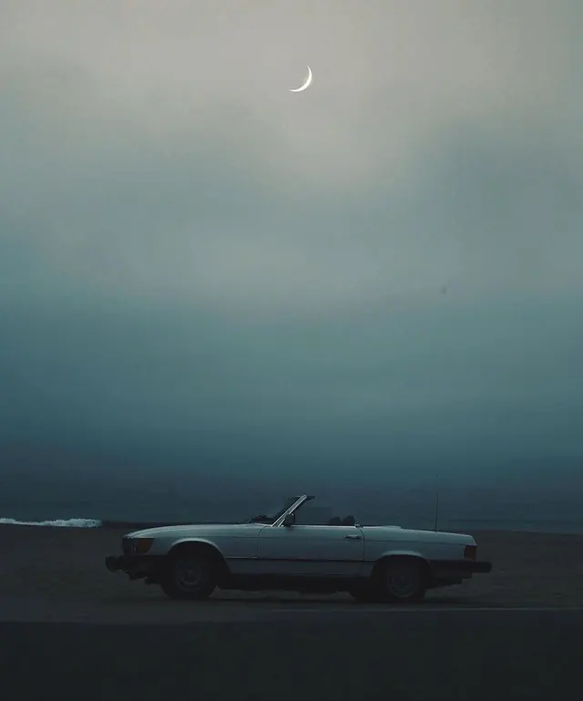 Vintage convertible under moonlit sky, photographic, minimal, cool