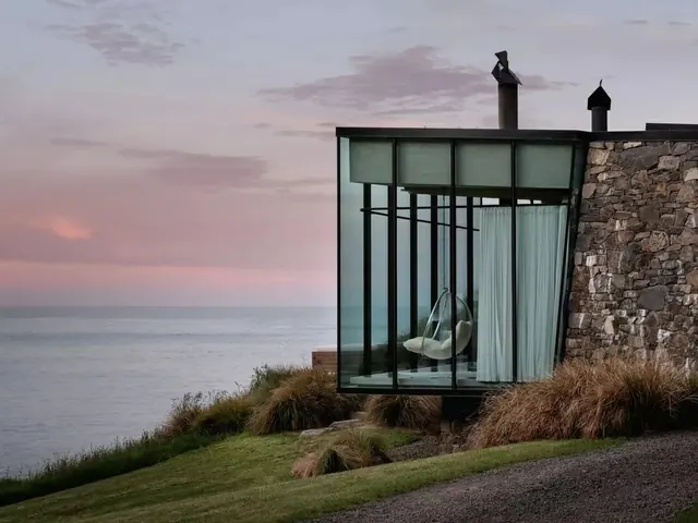 Contemporary glass cabin at sunset with sea view, architectural, photographic, cool