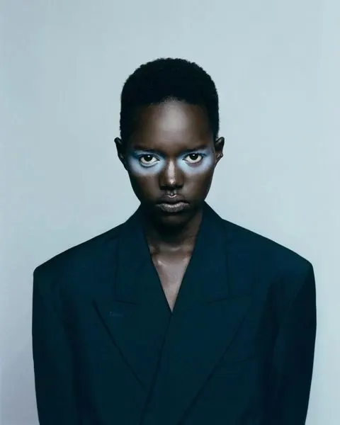 High-contrast editorial portrait with cool color grading, photographic, minimal, cool