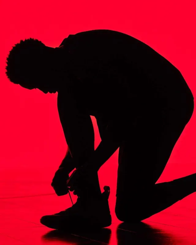 Silhouette dancer on red, photographic, minimalist, vibrant