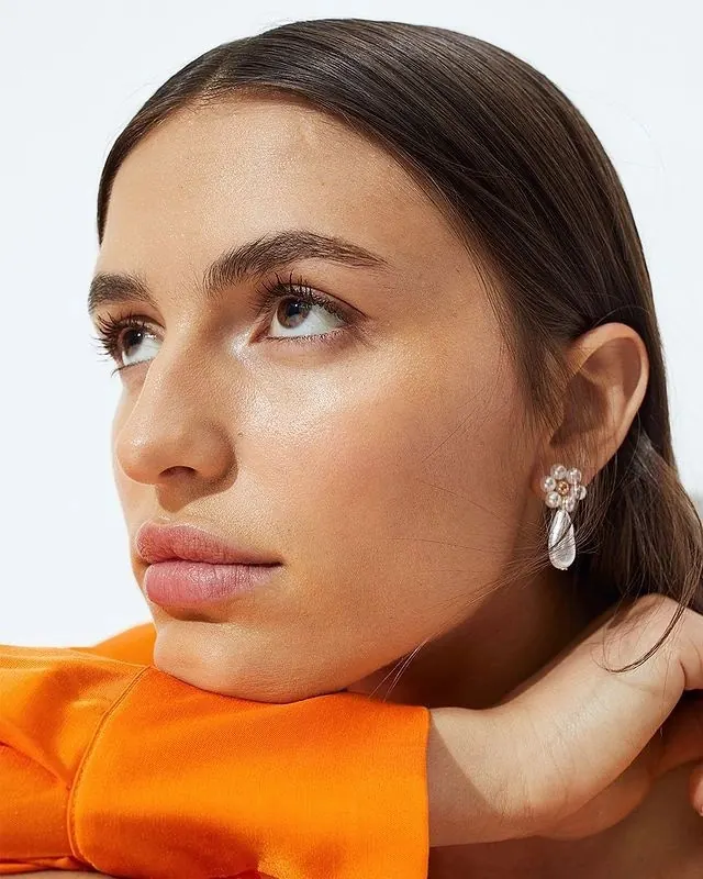 Woman portrait with orange accent, photographic, minimal, warm