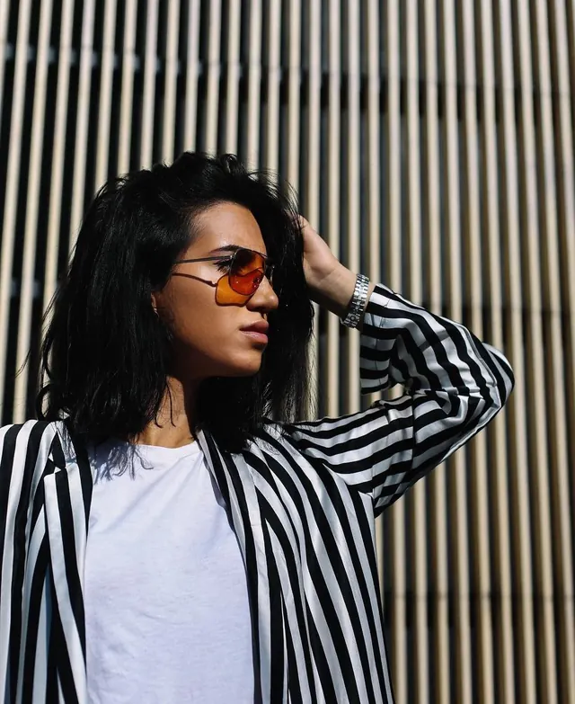 Portrait with orange tinted sunglasses, photographic, minimalist, warm