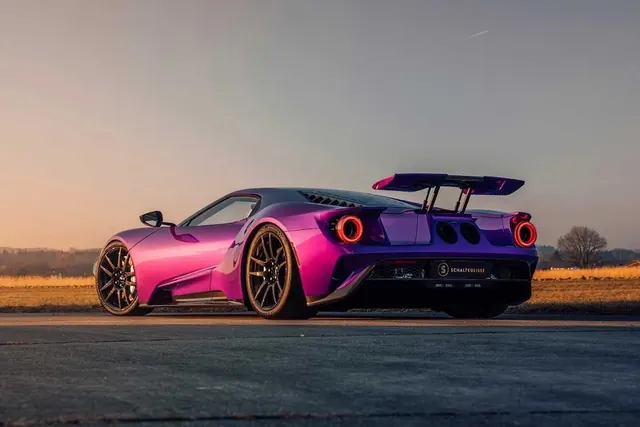 Pink sports car with wing profile, photographic, automotive, warm