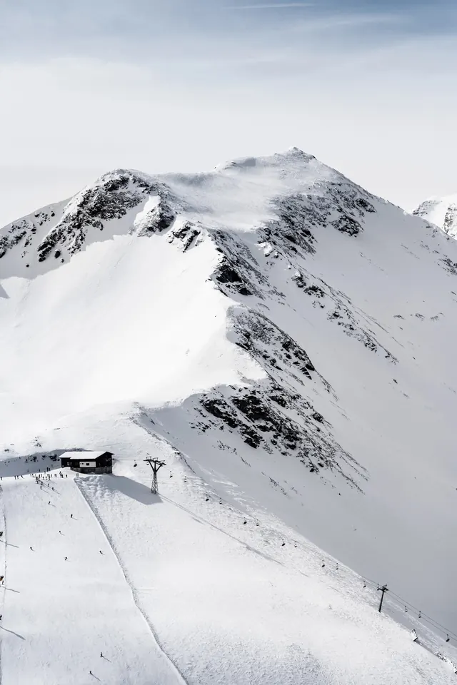 Alpine mountain landscape with ski lift, photographic, minimalist, light