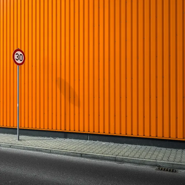 Orange Corrugated Wall with Speed Limit Sign