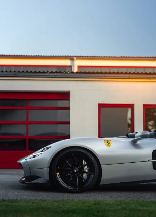 Silver Sports Car in Front of Industrial Building
