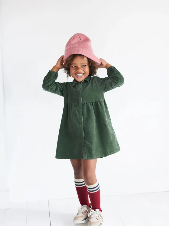 Child in Green Dress and Pink Hat
