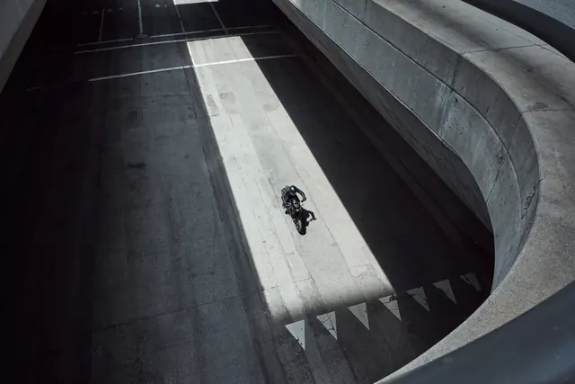 Aerial View of Motorcycle on Curved Road
