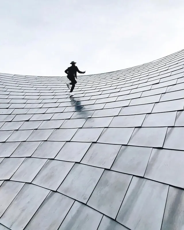 Person on Curved Tiled Roof