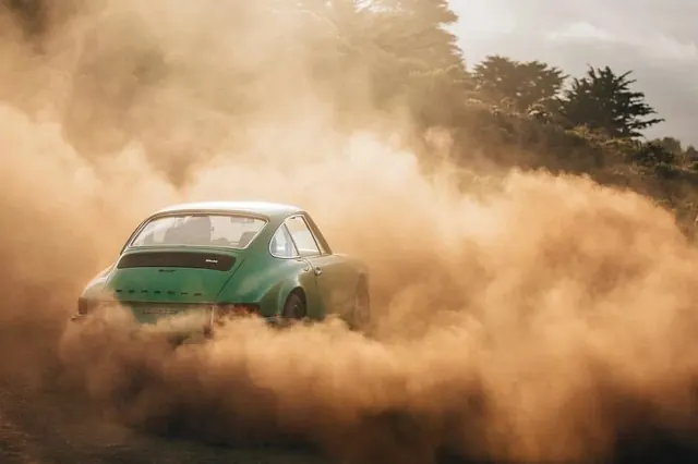 Off-road vehicle in dust cloud