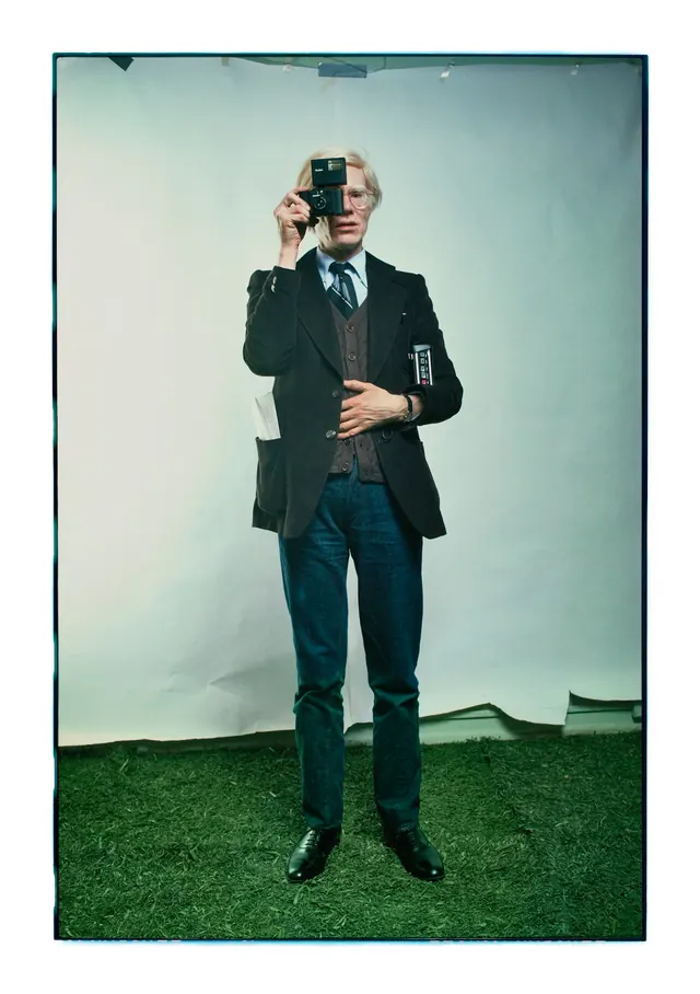 Man in Suit Standing on Grass