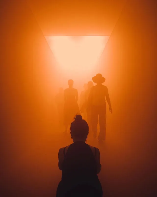 Silhouetted Figures in Orange Light
