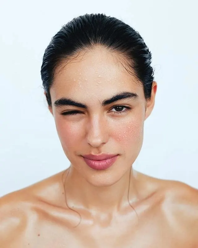 Portrait of a woman with slicked-back hair