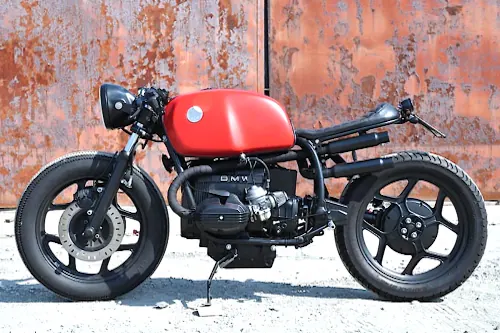 Red custom cafe racer motorcycle, minimal, photographic, warm