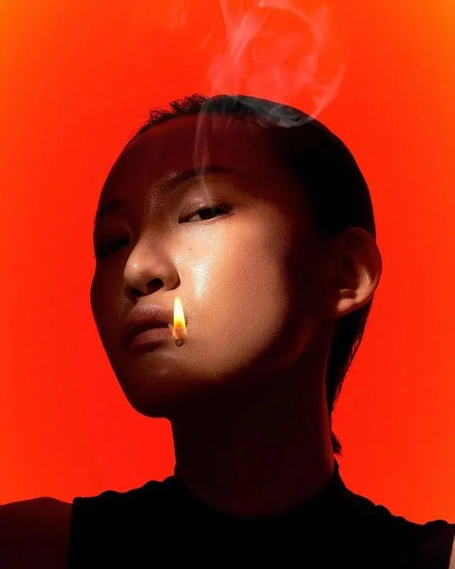 Portrait with fire effect and warm orange glow, photographic, editorial, warm