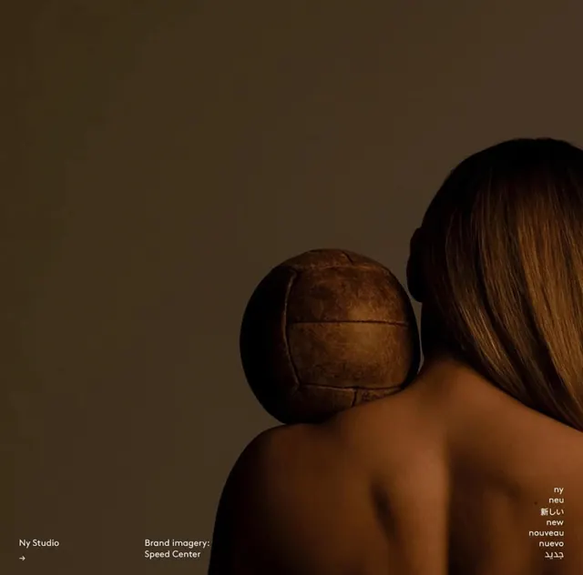 Studio portrait with worn leather ball, minimal, editorial, dark