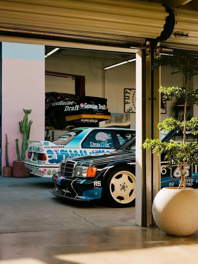 Garage interior with custom vintage Mercedes race cars, photographic, editorial, warm