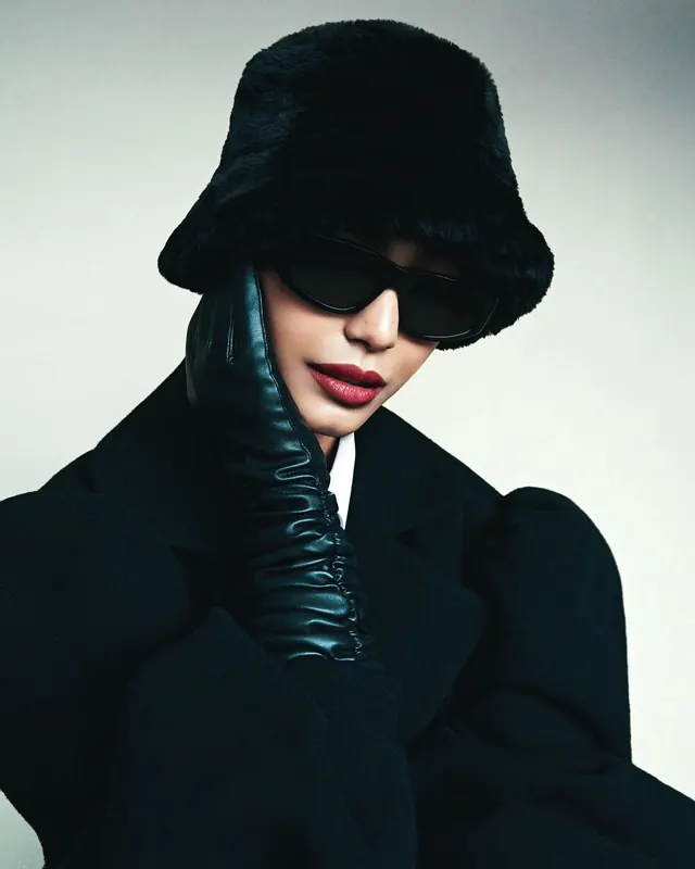 Fashion portrait in black fur hat with leather glove and red lips, photographic, editorial, dark