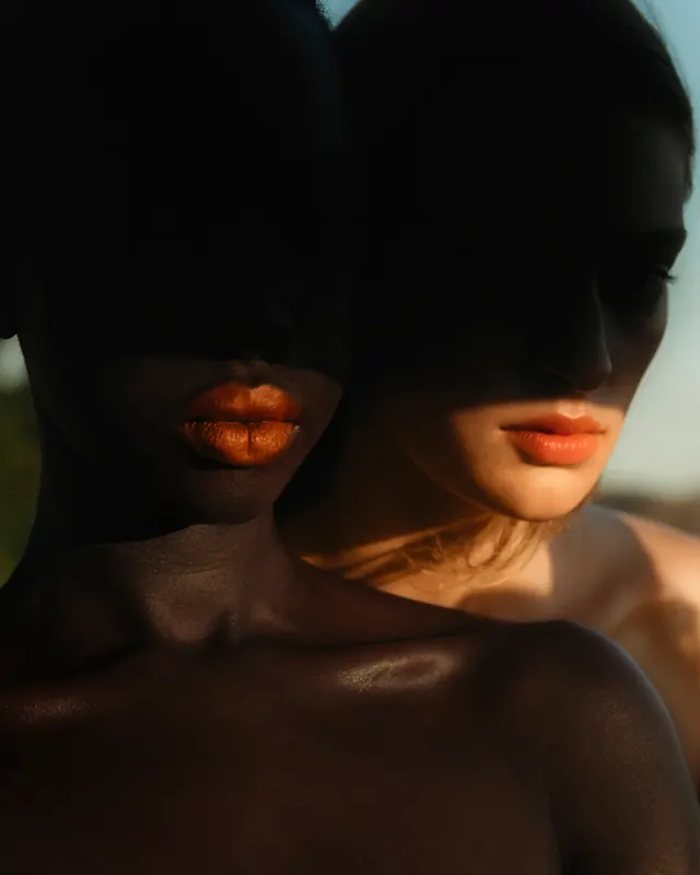 Dramatic beauty close-up with metallic lips, photographic, editorial, dark