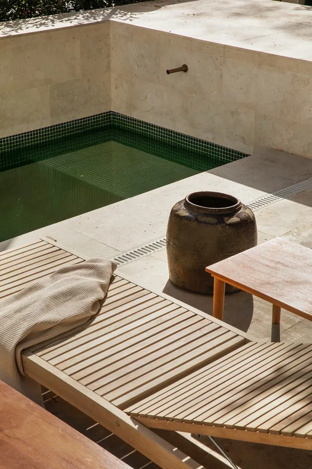 Mediterranean stone patio with plunge pool, minimal, photographic, earthy