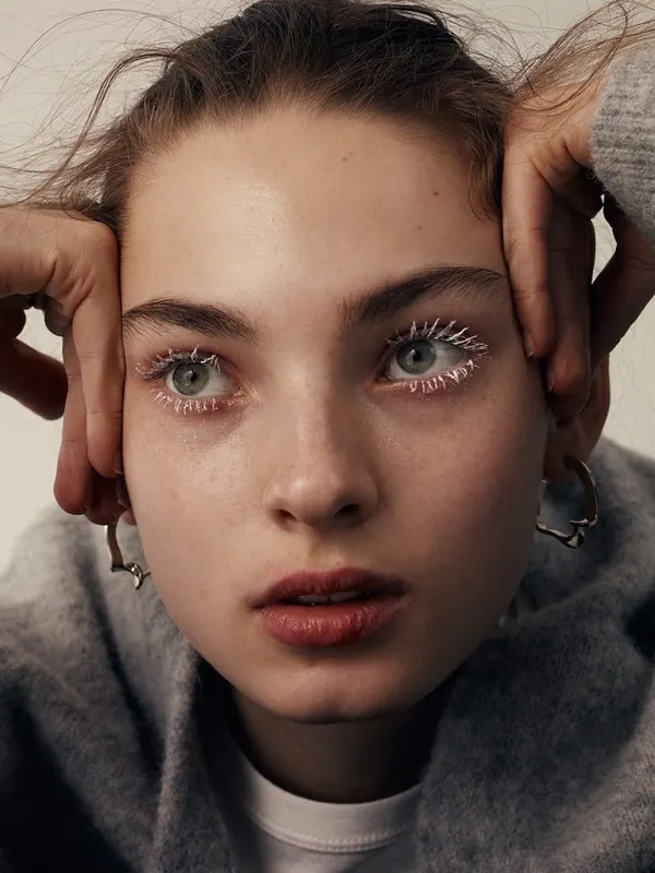 Beauty close-up with dramatic spiky eyelashes, photographic, editorial, muted