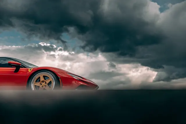 Red Sports Car in Stormy Landscape